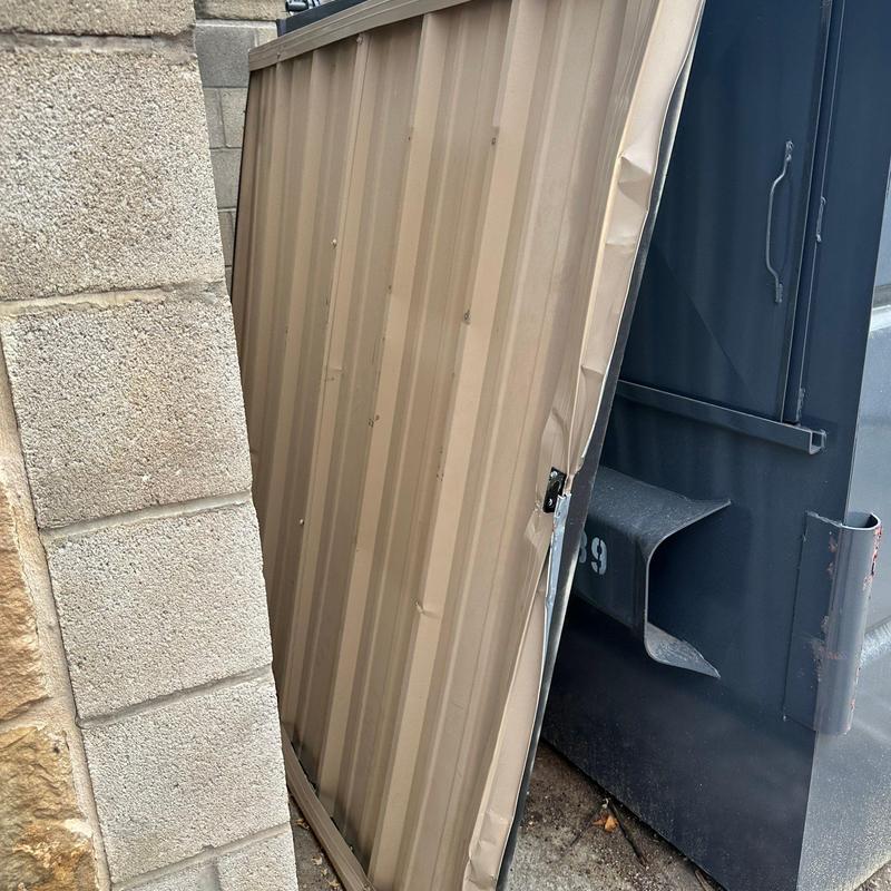 Metal trash enclosure gate panel dent and damage Metal trash enclosure gate panel dent and damage
