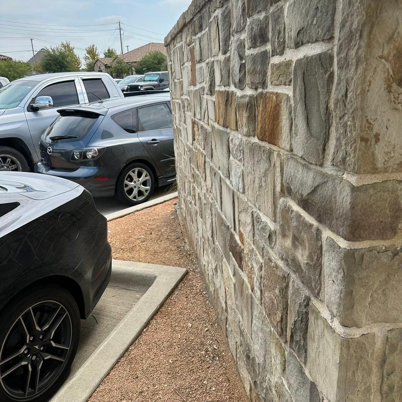 Stone wall repair near parking lot curb Stone wall repair near parking lot curb