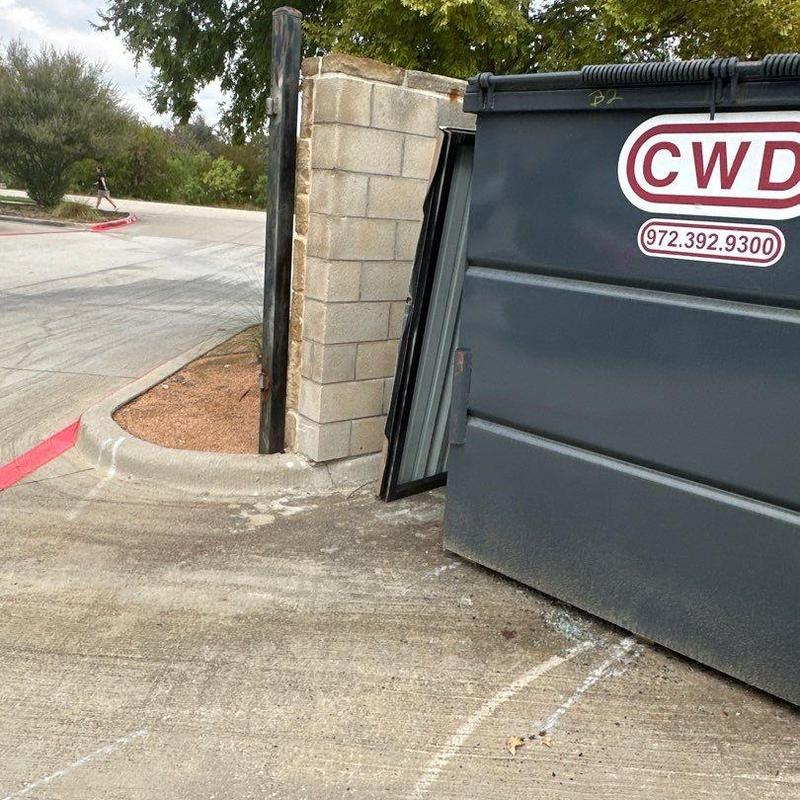 Stonework and gate panel at trash enclosure damaged Stonework and gate panel at trash enclosure damaged