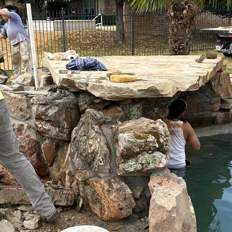 Natural stone waterfall rebuild beside pool Natural stone waterfall rebuild beside pool