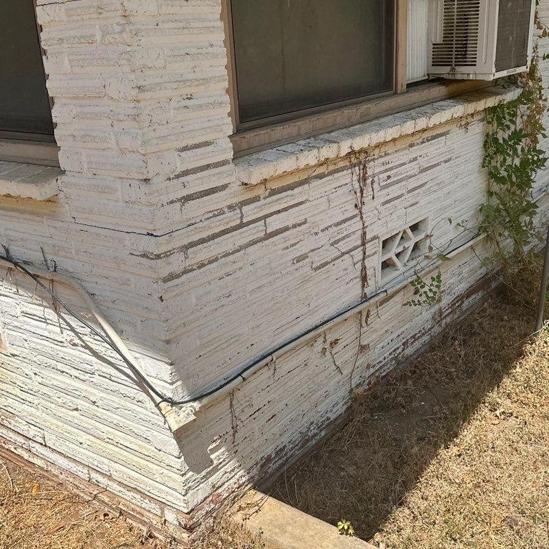 Brick masonry exterior wall with cracking and dirt stains Brick masonry exterior wall with cracking and dirt stains