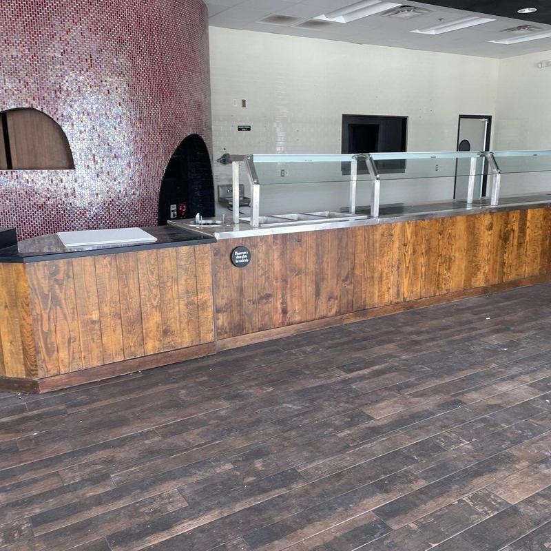 Serving counter with glass sneeze guard and wood paneling Serving counter with glass sneeze guard and wood paneling