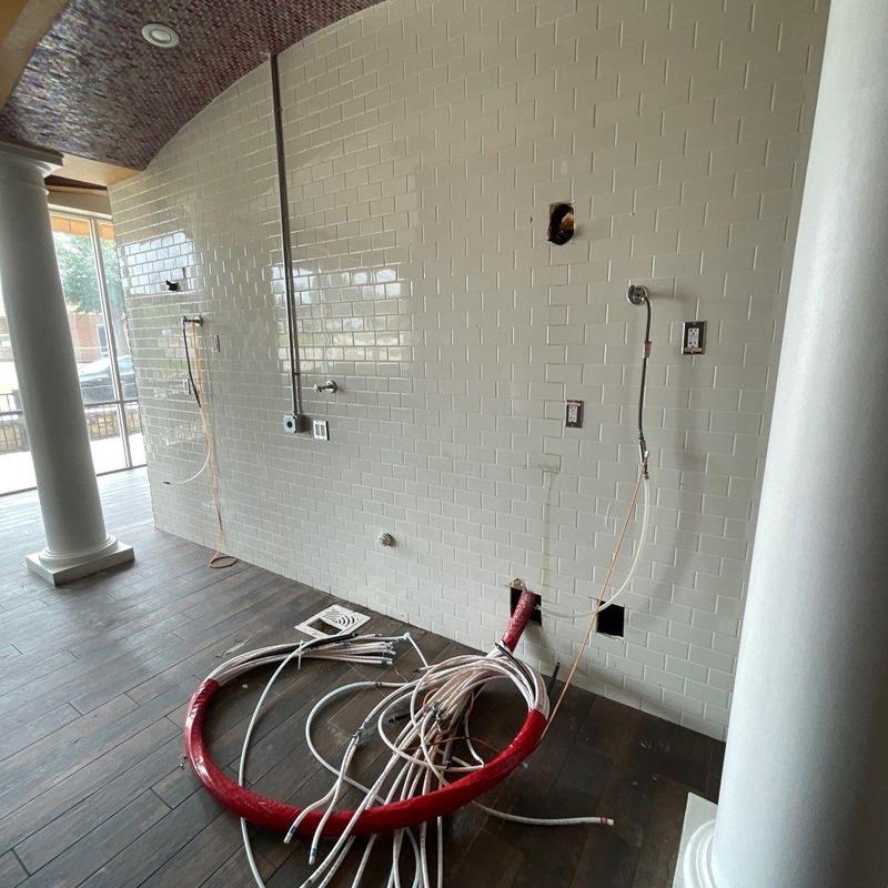 Tile wall with electrical wiring and plumbing setup Tile wall with electrical wiring and plumbing setup