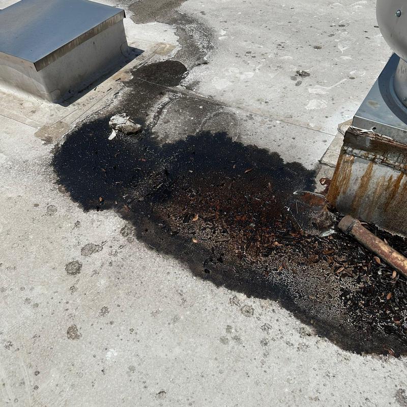Concrete roof surface with weathered sealant patches Concrete roof surface with weathered sealant patches