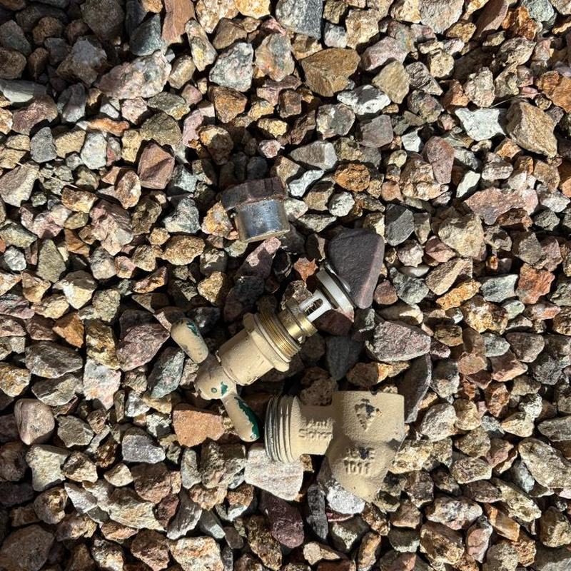 Old hose bib removed on gravel ground