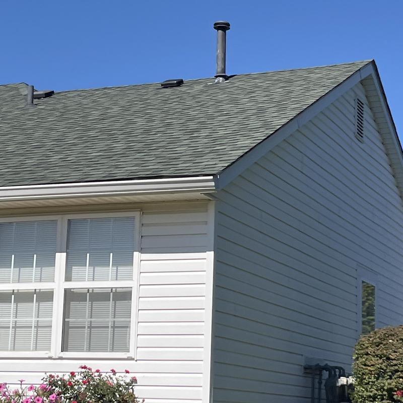 Asphalt shingle roof with vent pipes on residential house