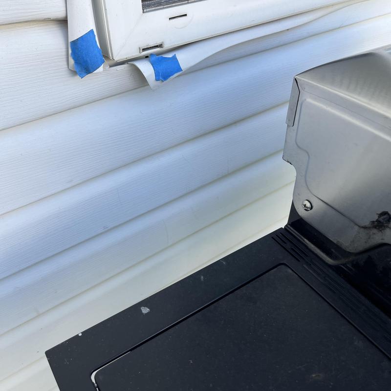 Vinyl siding with vent and grill repair detail