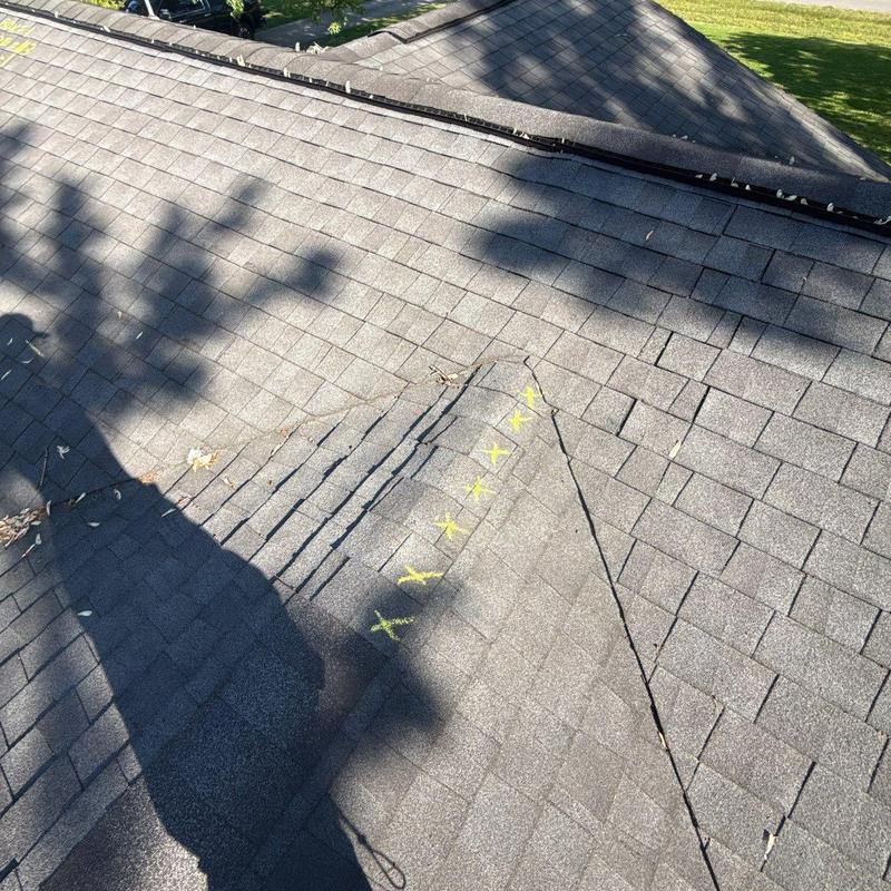 Asphalt roof shingles with marked hail damage spots