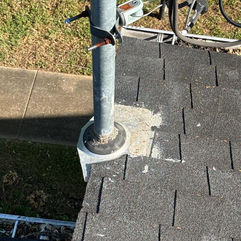 Roof vent flashing on asphalt shingle roof with sealant repairs
