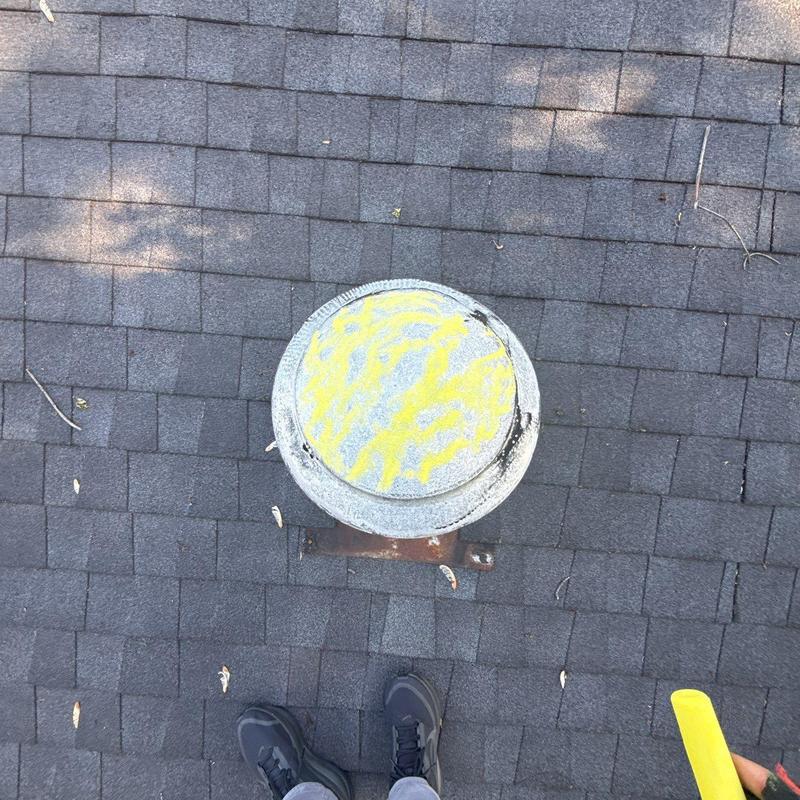Roof vent pipe on shingled roof with inspection marks
