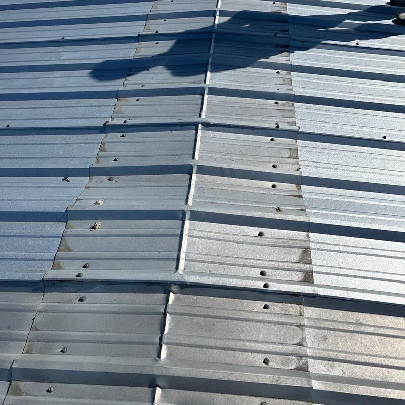 Metal roof panels with hail damage and corrosion marks