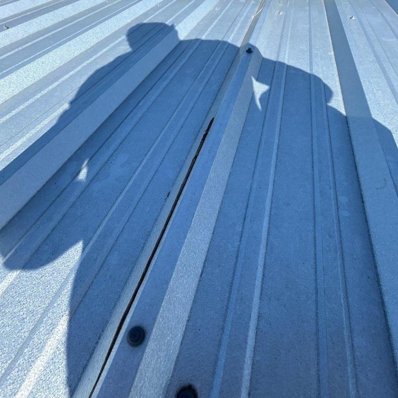Metal roof panel gap showing separation and bolt fasteners