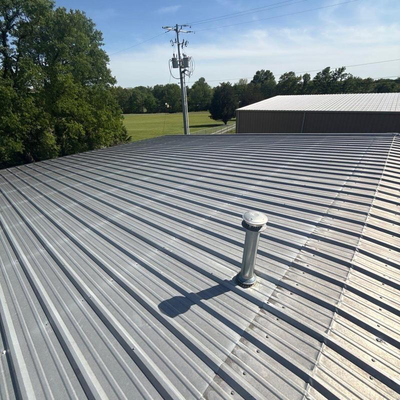 Metal roof panels with vent pipe installation