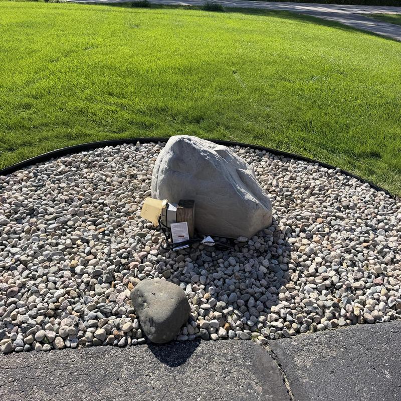 Septic alarm system sensor by decorative rock bed