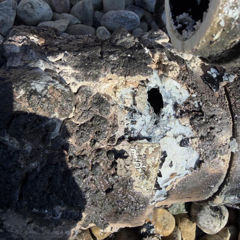 Corroded sewage pump casing with damage and debris