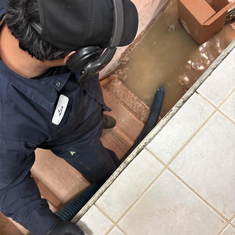 Main line water drainage with technician inspecting Main line water drainage with technician inspecting