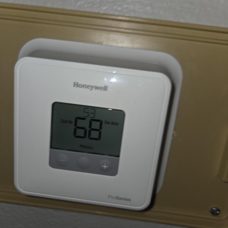 Honeywell ProSeries thermostat on wall panel Honeywell ProSeries thermostat on wall panel