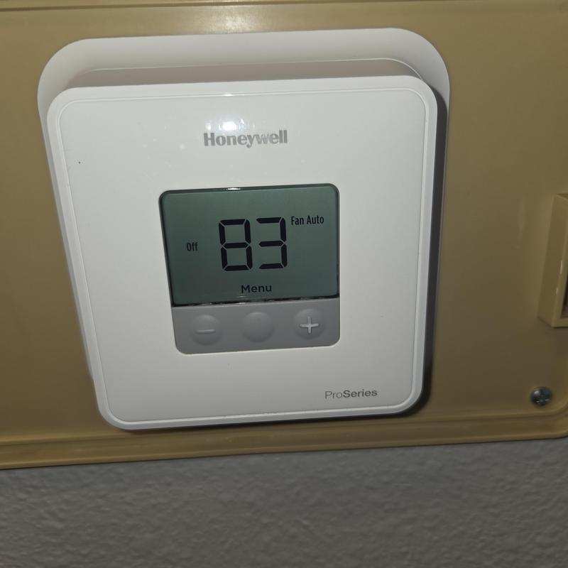 Honeywell thermostat control panel on wall display Honeywell thermostat control panel on wall display