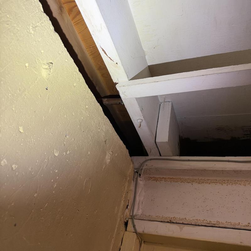 Basement ceiling beam with exposed wood and wiring