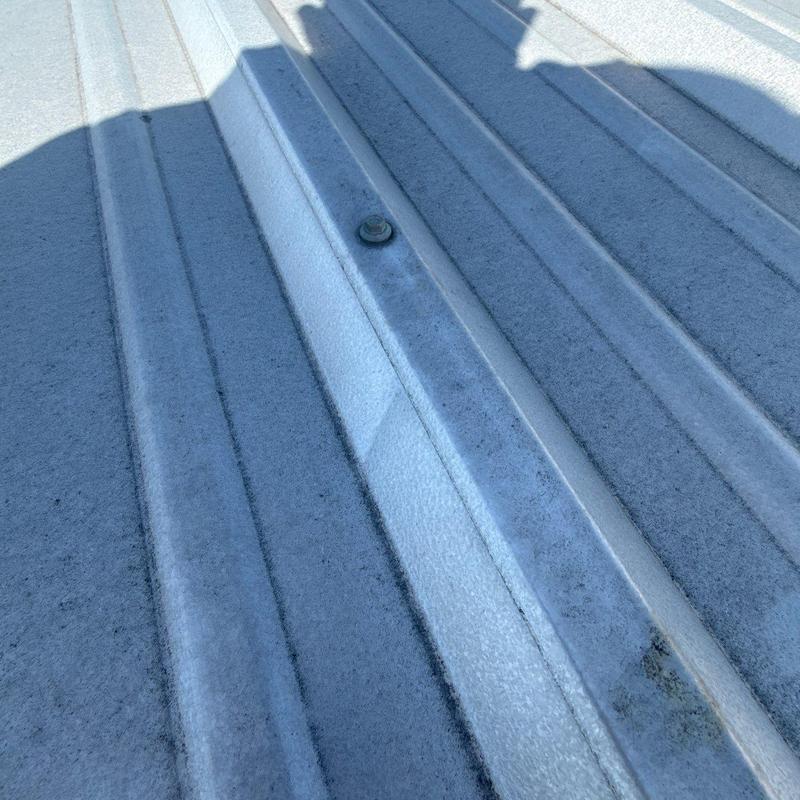Metal roofing panel with fastener and shadows