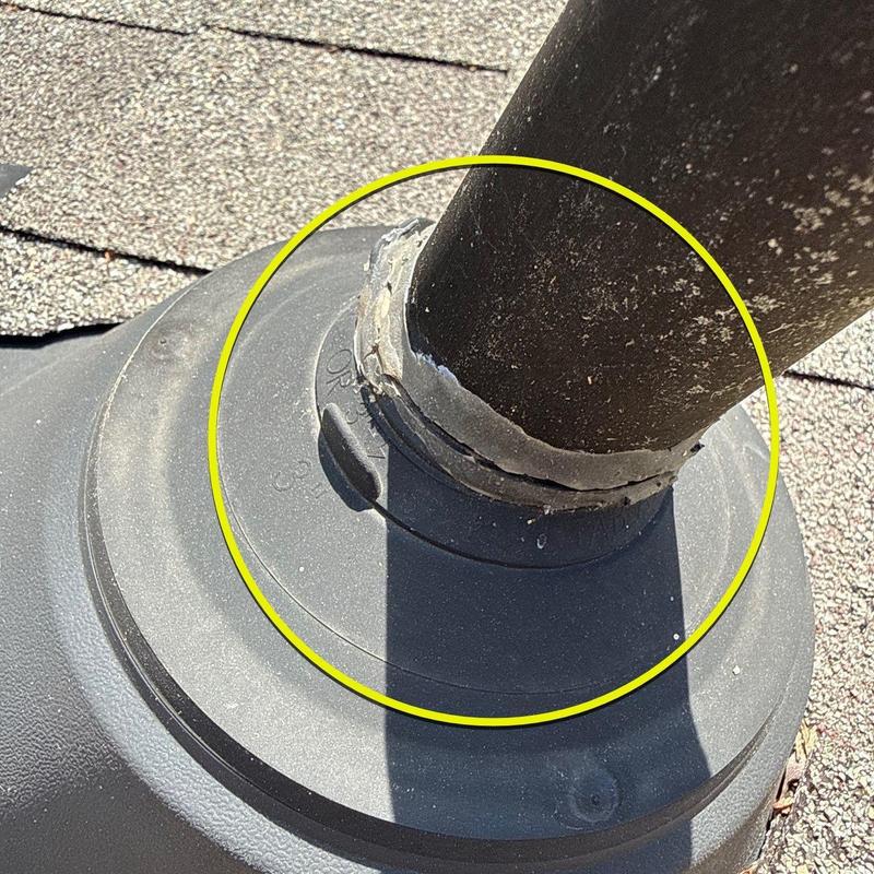 Roof vent pipe flashing with cracked sealant on shingle roof