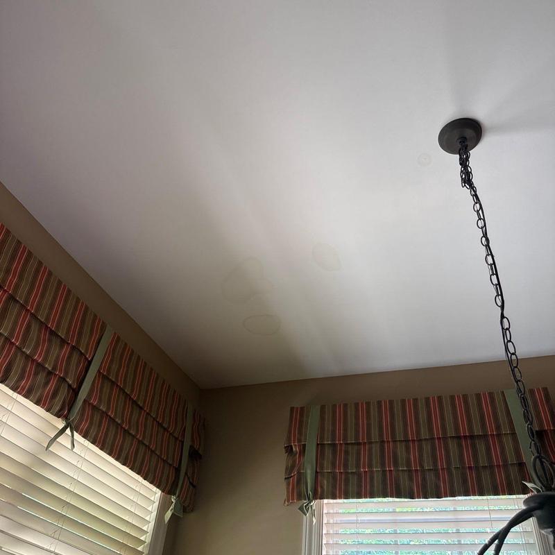 Ceiling water stains near light fixture and windows