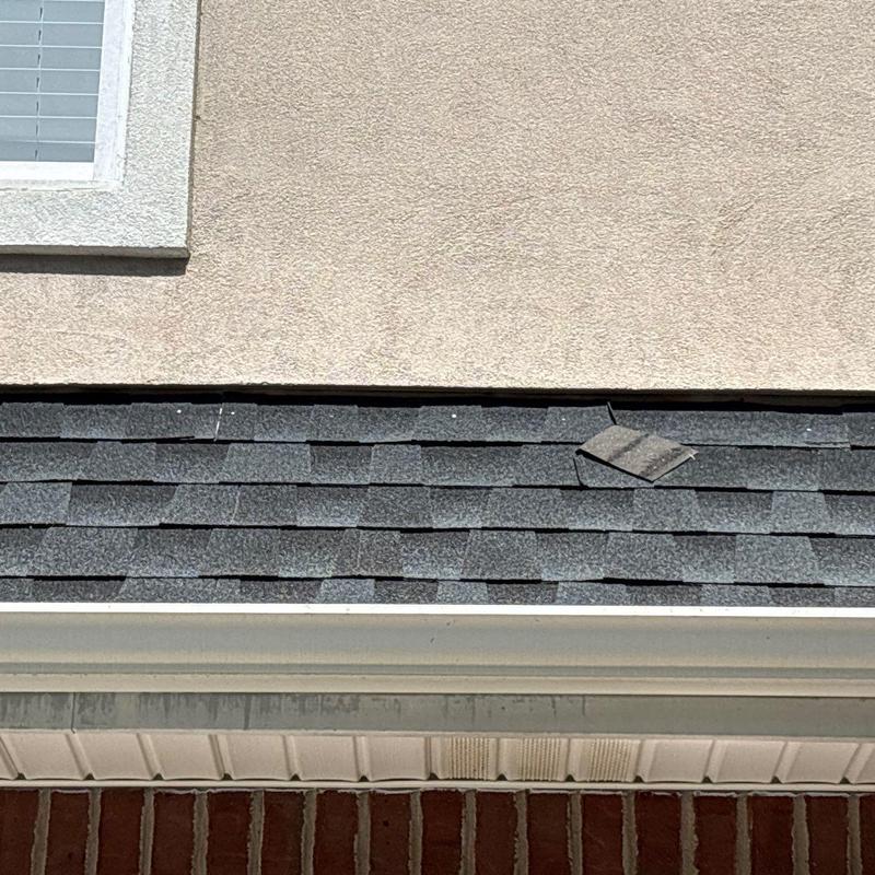 Roof shingles with hail damage on residential home