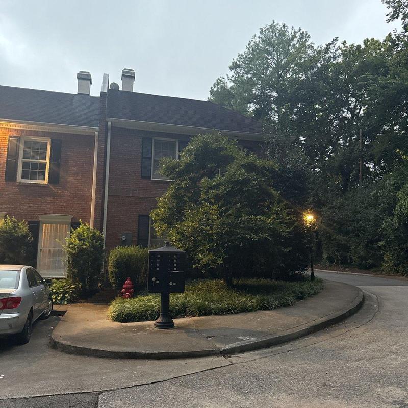 Asphalt shingle roof on brick townhome evening view Asphalt shingle roof on brick townhome evening view
