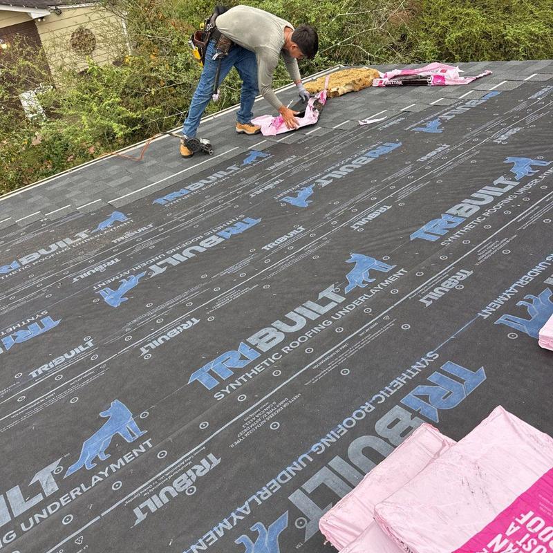 Synthetic roofing underlayment installation on roof deck Synthetic roofing underlayment installation on roof deck