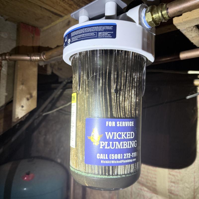 Water filter housing with cartridge installed in basement