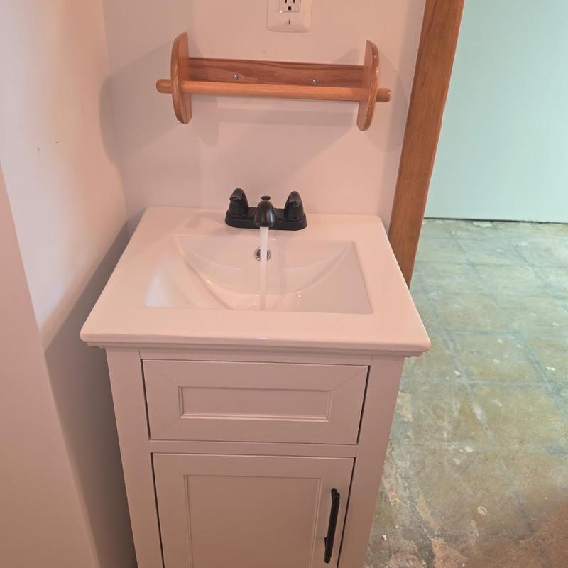 Vanity sink with black faucet and running water