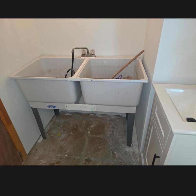 Laundry tub installation with dual basins and faucet