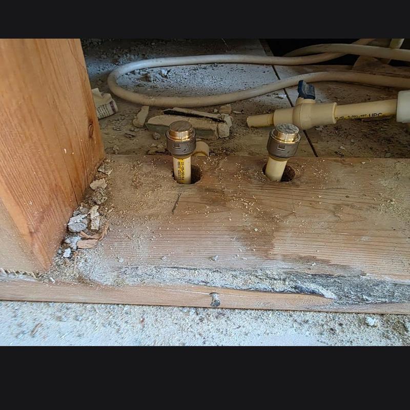 CPVC hot and cold water lines cut and capped in floor