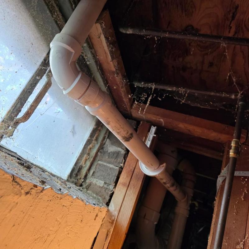 Kitchen drain pipe installation under floor joists
