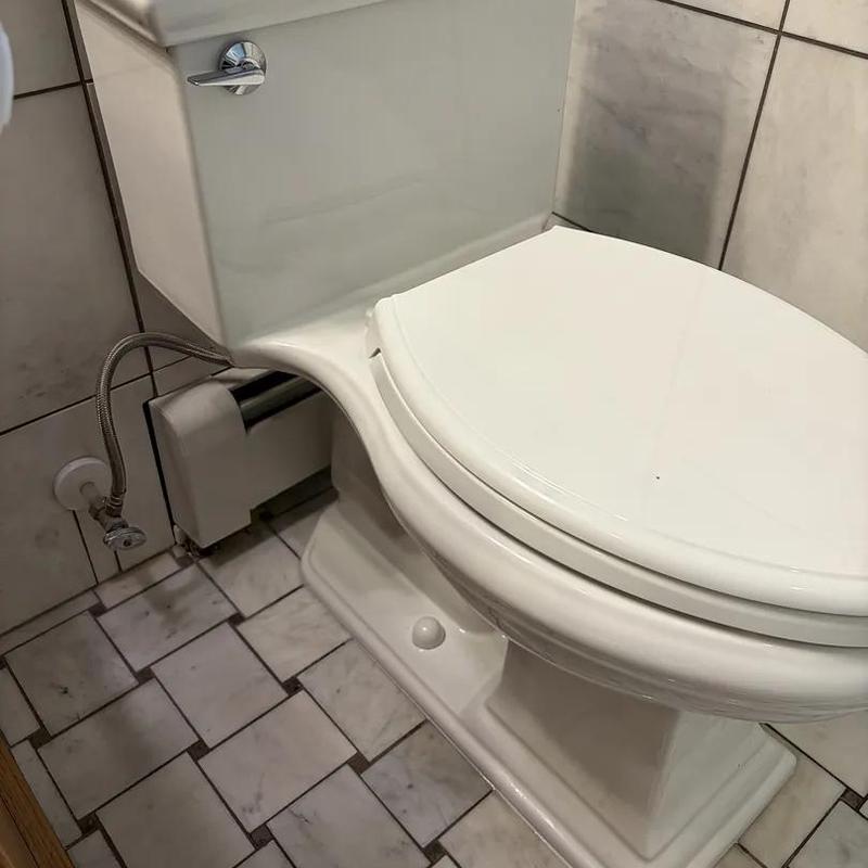 Toilet installation on tiled bathroom floor