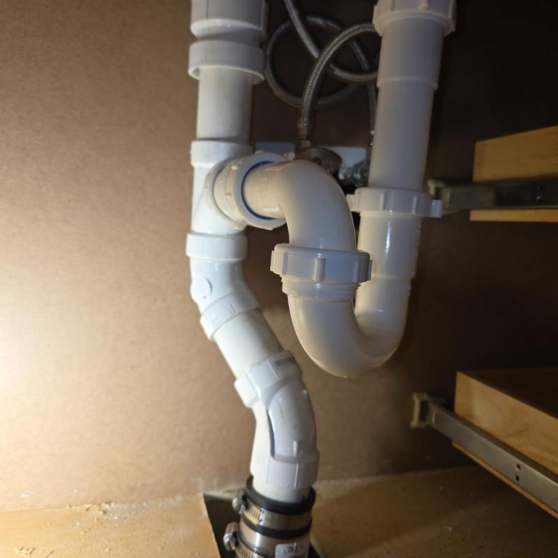P-trap and drain pipes under sink installation