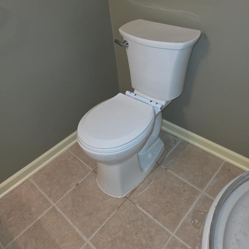 Toilet installation on tiled bathroom floor