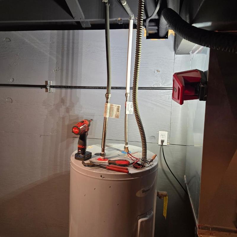 Water heater replacement with plumber tools and drill