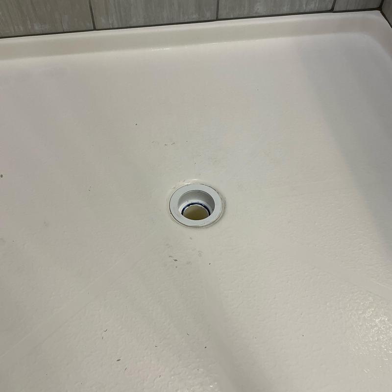 Shower drain opening in white shower base