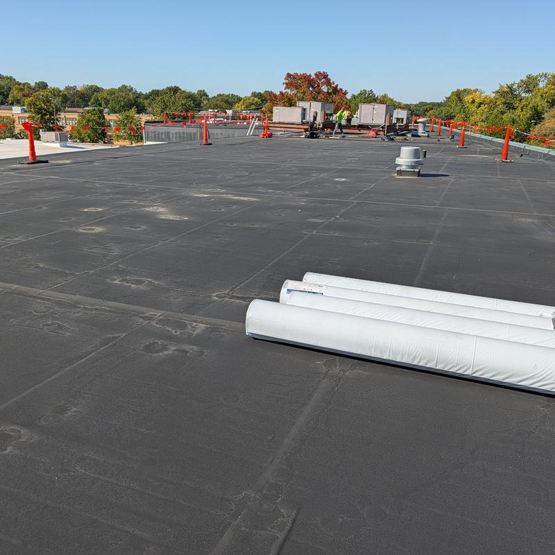 EPDM flat commercial roof with TPO restoration rolls