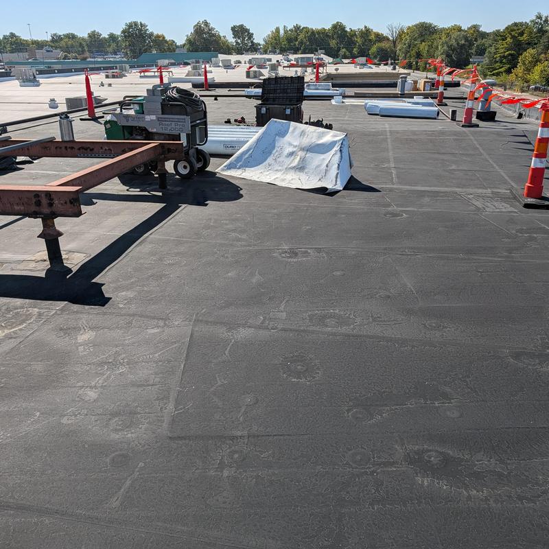 EPDM flat commercial roof with restoration tools