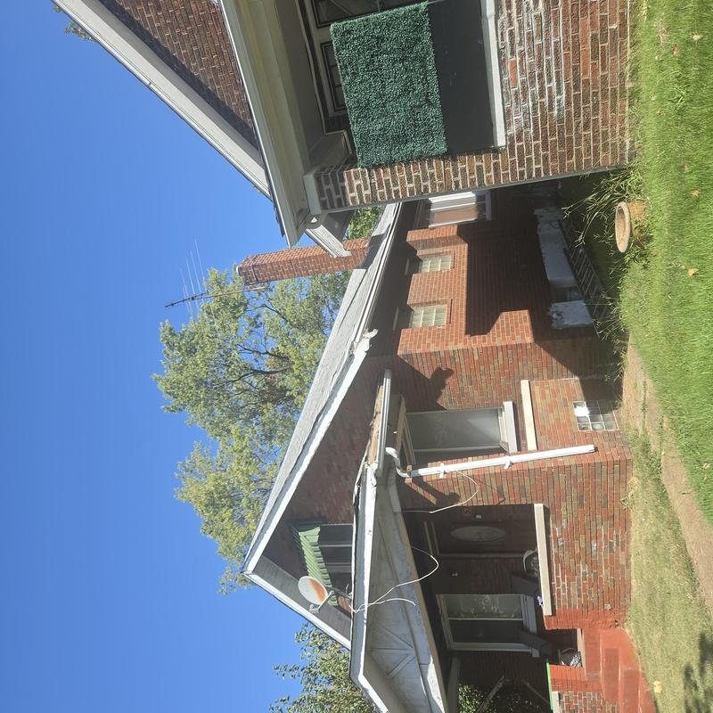 Roof fascia board inspection on residential brick house