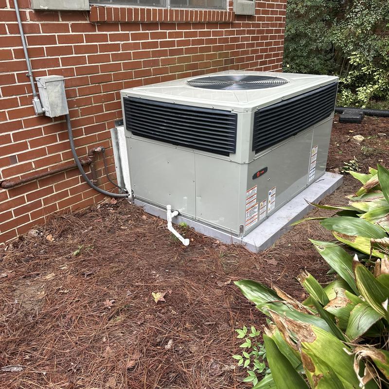 Gas pack HVAC system installed on concrete pad outdoors Gas pack HVAC system installed on concrete pad outdoors