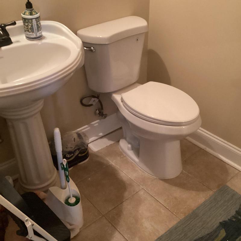 Toilet and pedestal sink installed on tile floor Toilet and pedestal sink installed on tile floor