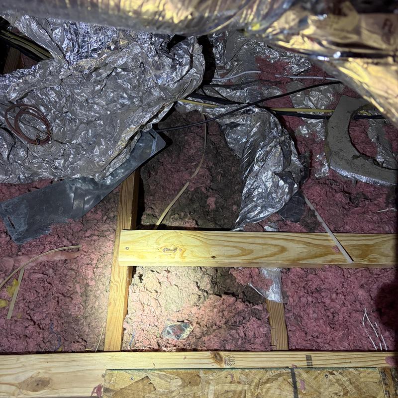 Fiberglass attic insulation with foil vapor barrier in crawl space
