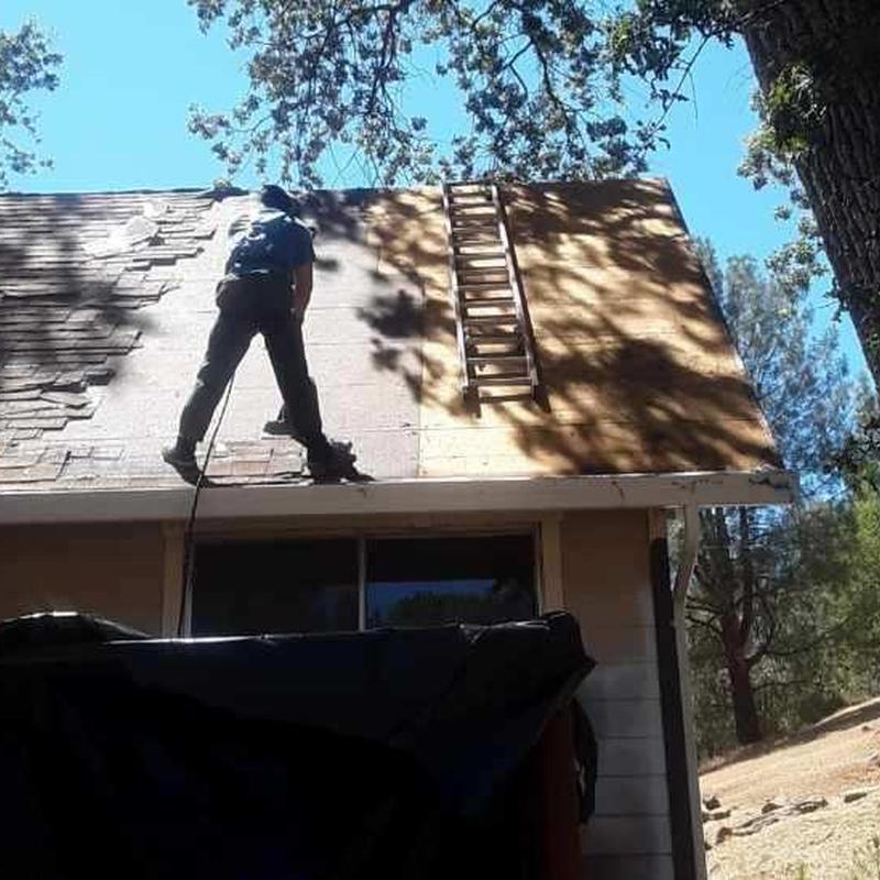Asphalt roof deck prep with ladder and roofer