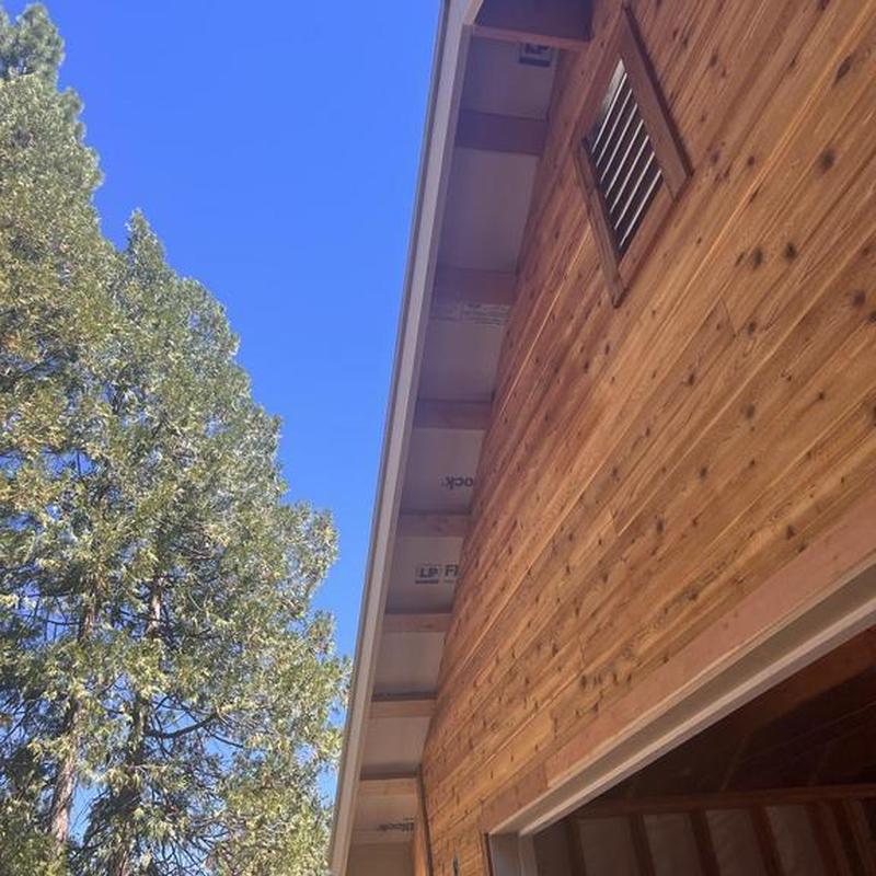 Cabin wood siding with vent and clear sky