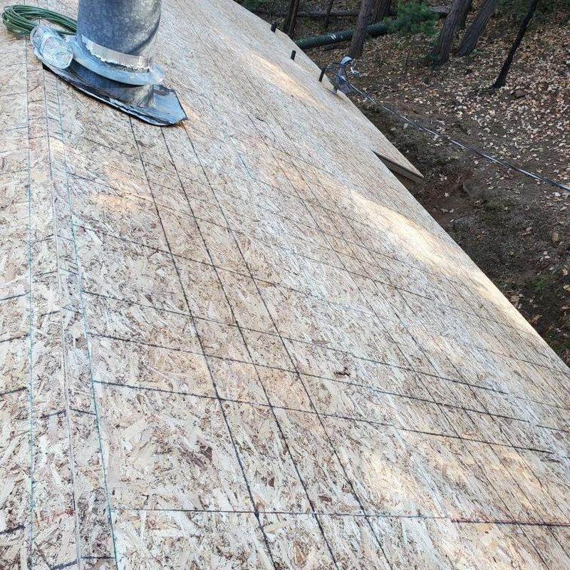Oriented strand board roof deck with pipe flashing