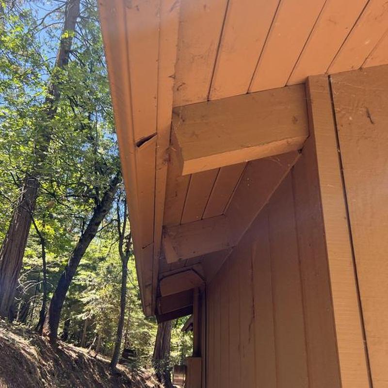Wooden soffit and fascia repair on cabin exterior