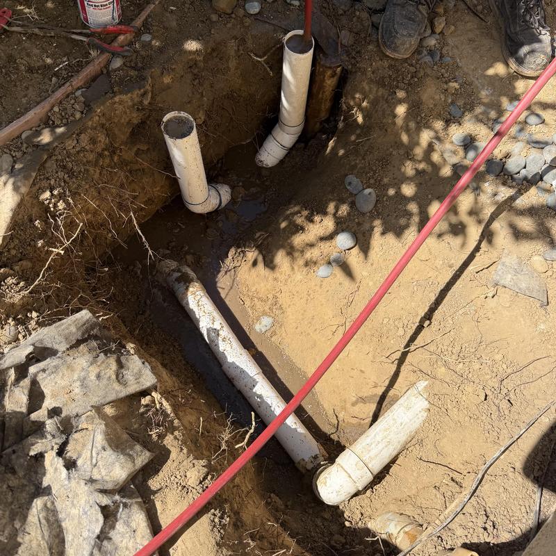Storm drain two-way clean out installation in dirt trench Storm drain two-way clean out installation in dirt trench